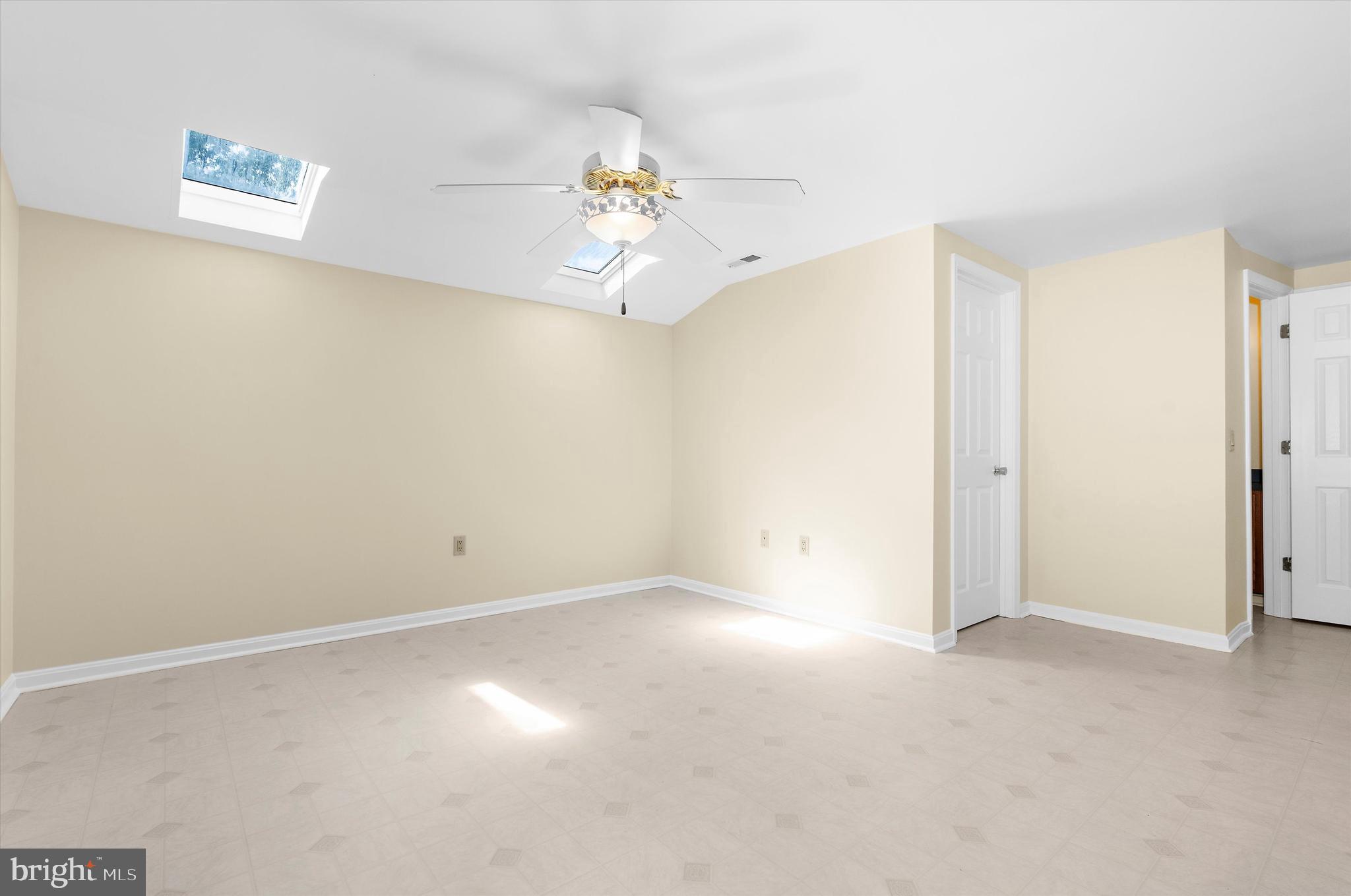 12714 Still Pond Road Still Pond, MD 21667 - Photo 37 of 62 an empty room with a chandelier fan and windows