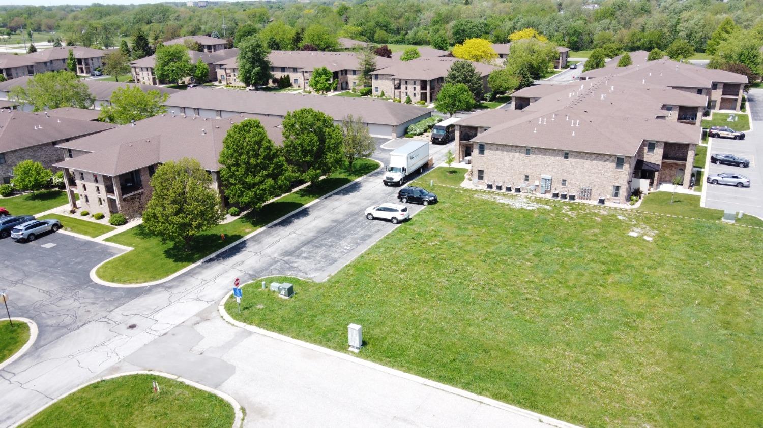 an aerial view of residential houses with yard