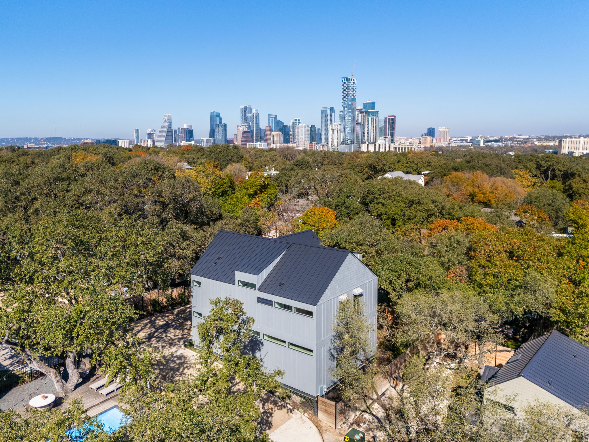 1603 Chelsea Lane, Unit 1 Austin, TX 78704 - Photo 4 of 34 An aerial perspective showcases a modern metal roof standing out against the city skyline.