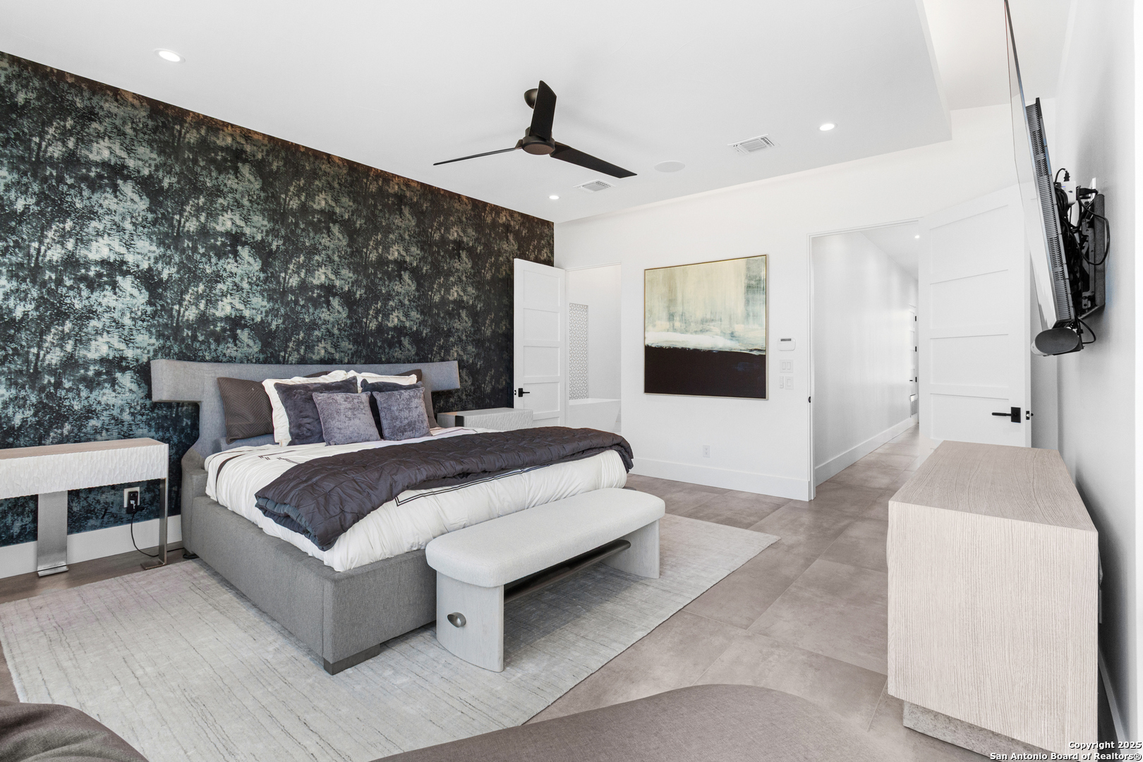 135 Whittingham Road San Antonio, TX 78231 - Photo 12 of 43 a spacious bedroom with a bed and a flat screen tv