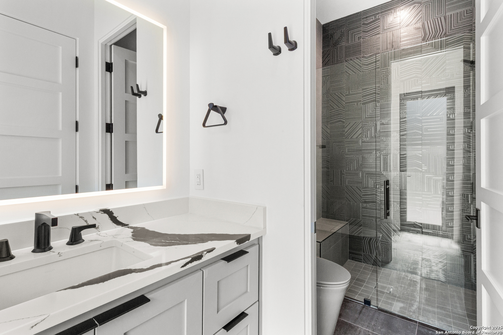 135 Whittingham Road San Antonio, TX 78231 - Photo 25 of 43 a bathroom with a granite countertop sink toilet and shower