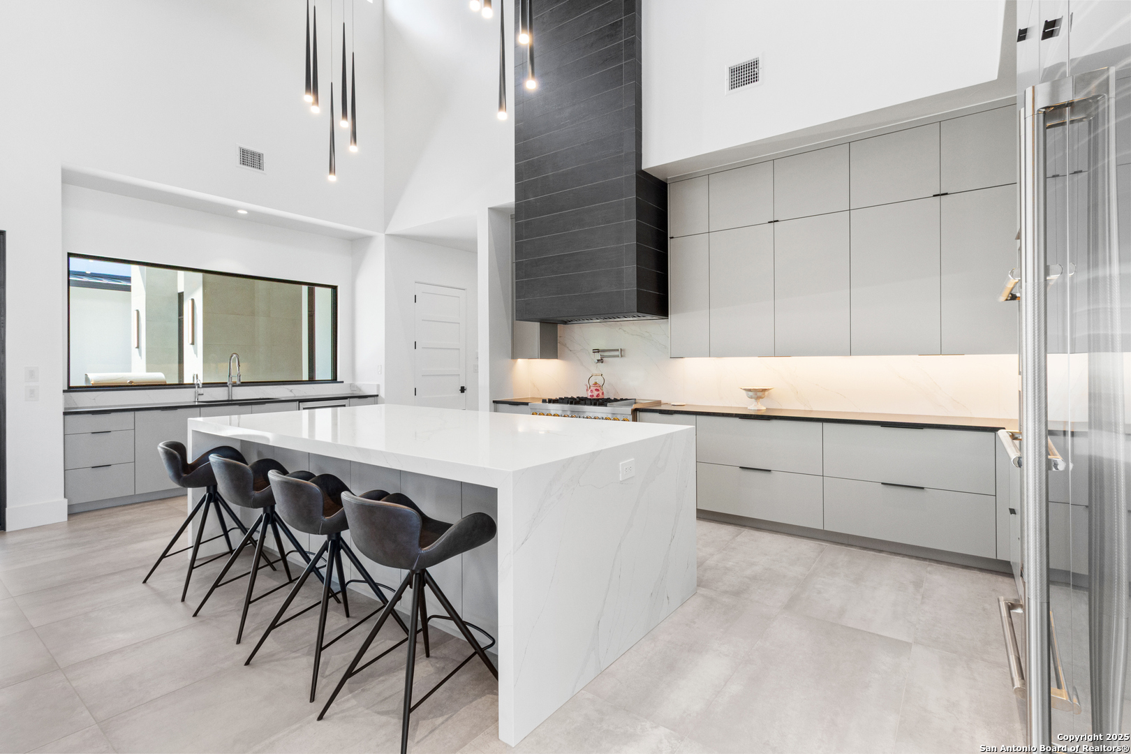 135 Whittingham Road San Antonio, TX 78231 - Photo 7 of 43 a kitchen with a sink a table and chairs in it