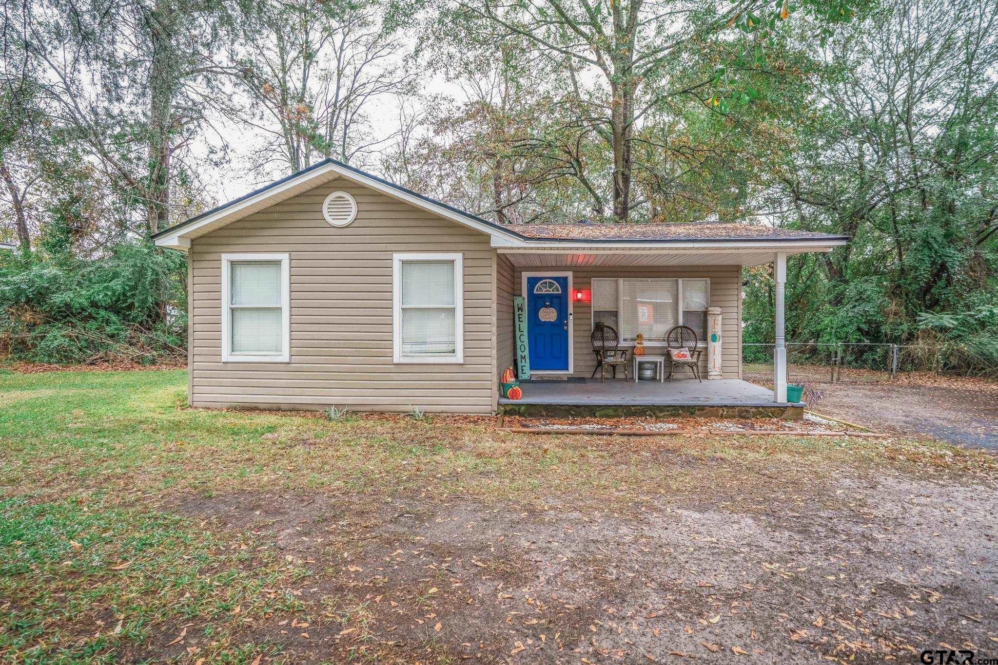 a front view of house with yard and green space