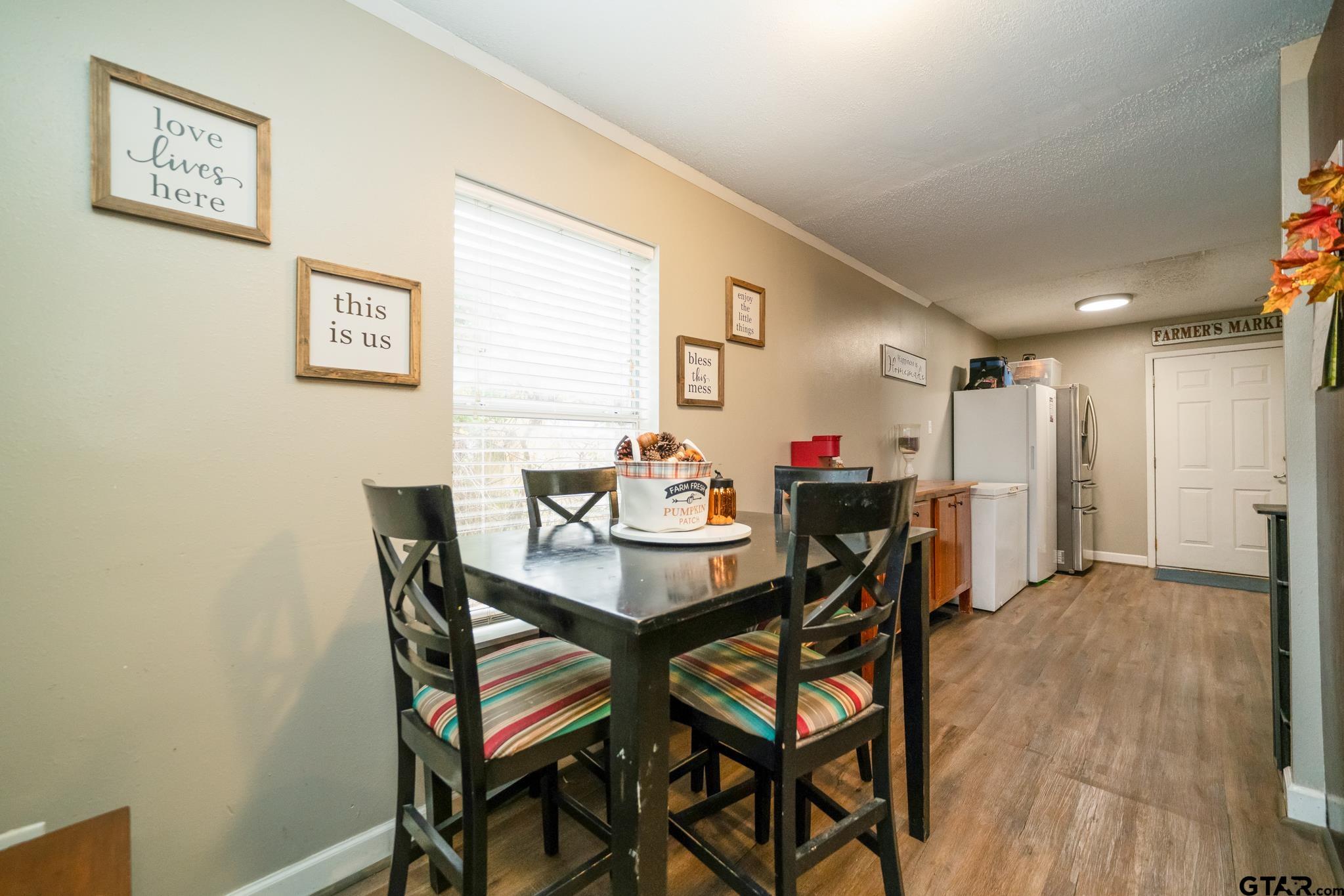 208 East Center Street White Oak, TX 75693 - Photo 16 of 31 a dining room with furniture and a potted plant