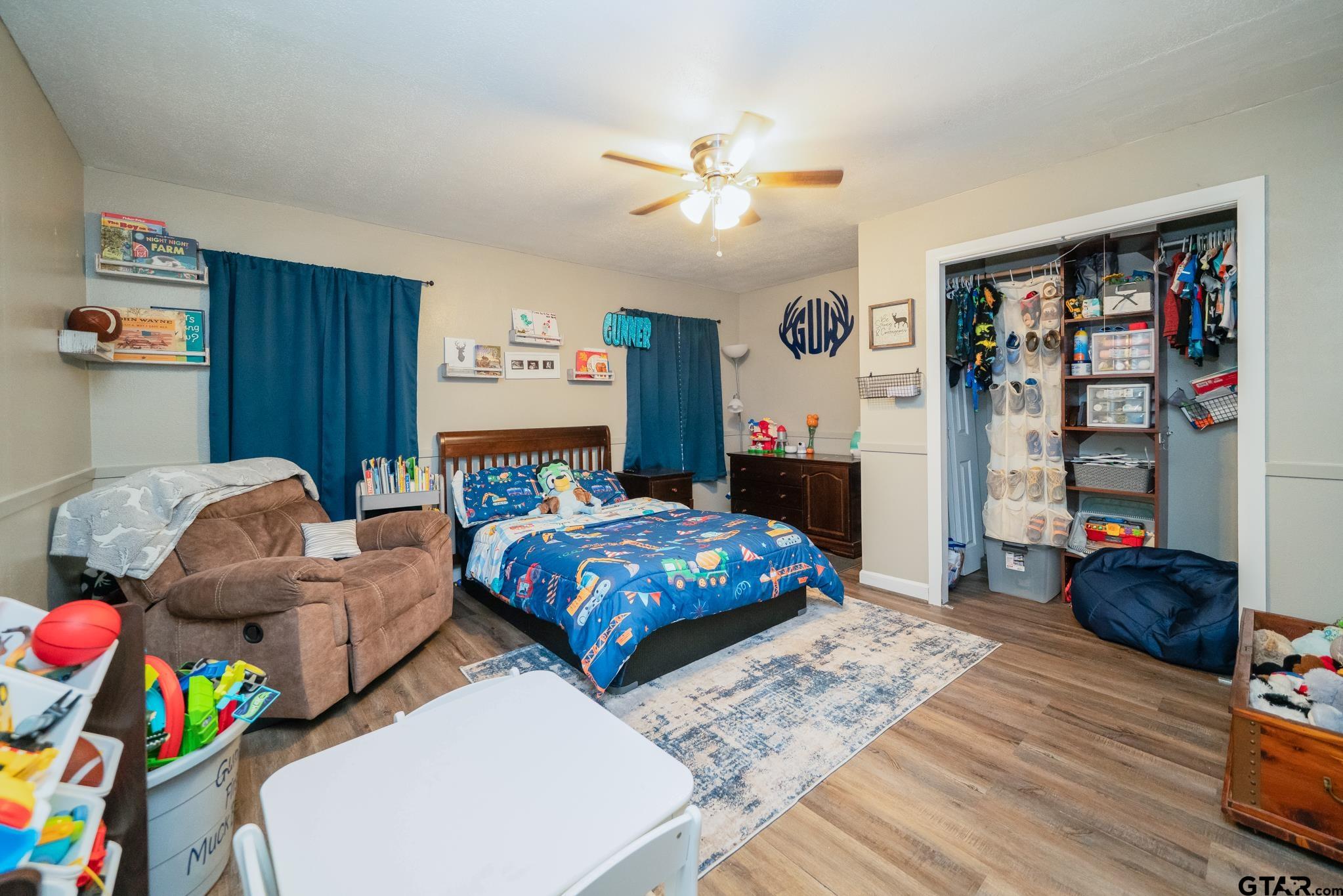 208 East Center Street White Oak, TX 75693 - Photo 21 of 31 a living room with furniture and a baby crib