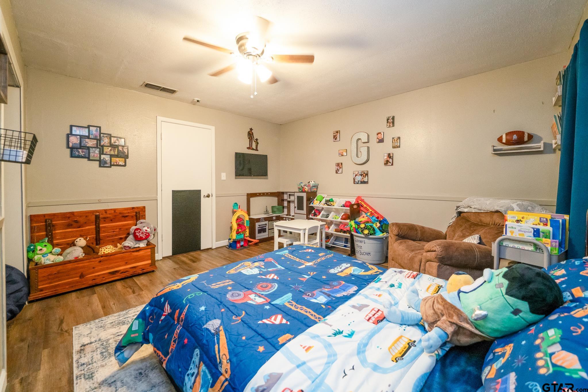 208 East Center Street White Oak, TX 75693 - Photo 22 of 31 a bedroom with furniture and a flat screen tv