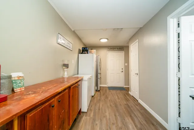 a view of a hallway with wooden floor