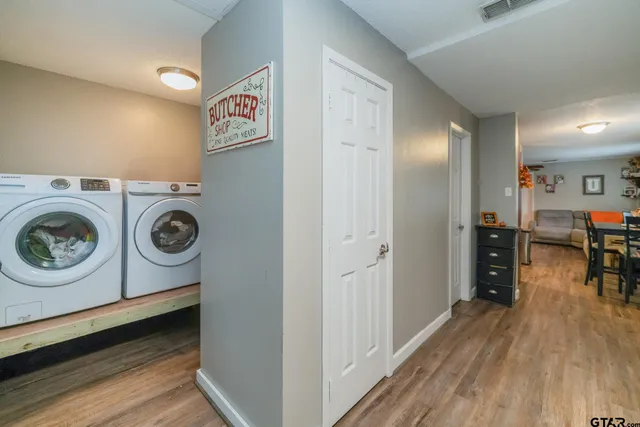 a view of washer and dryer with wooden floor