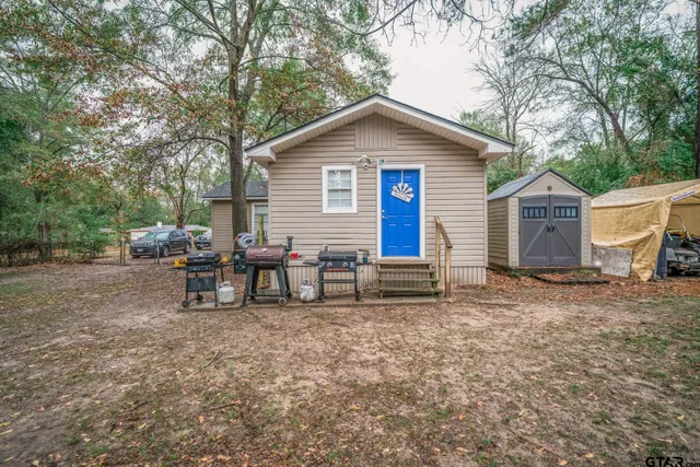 a view of a house with a yard and sitting area