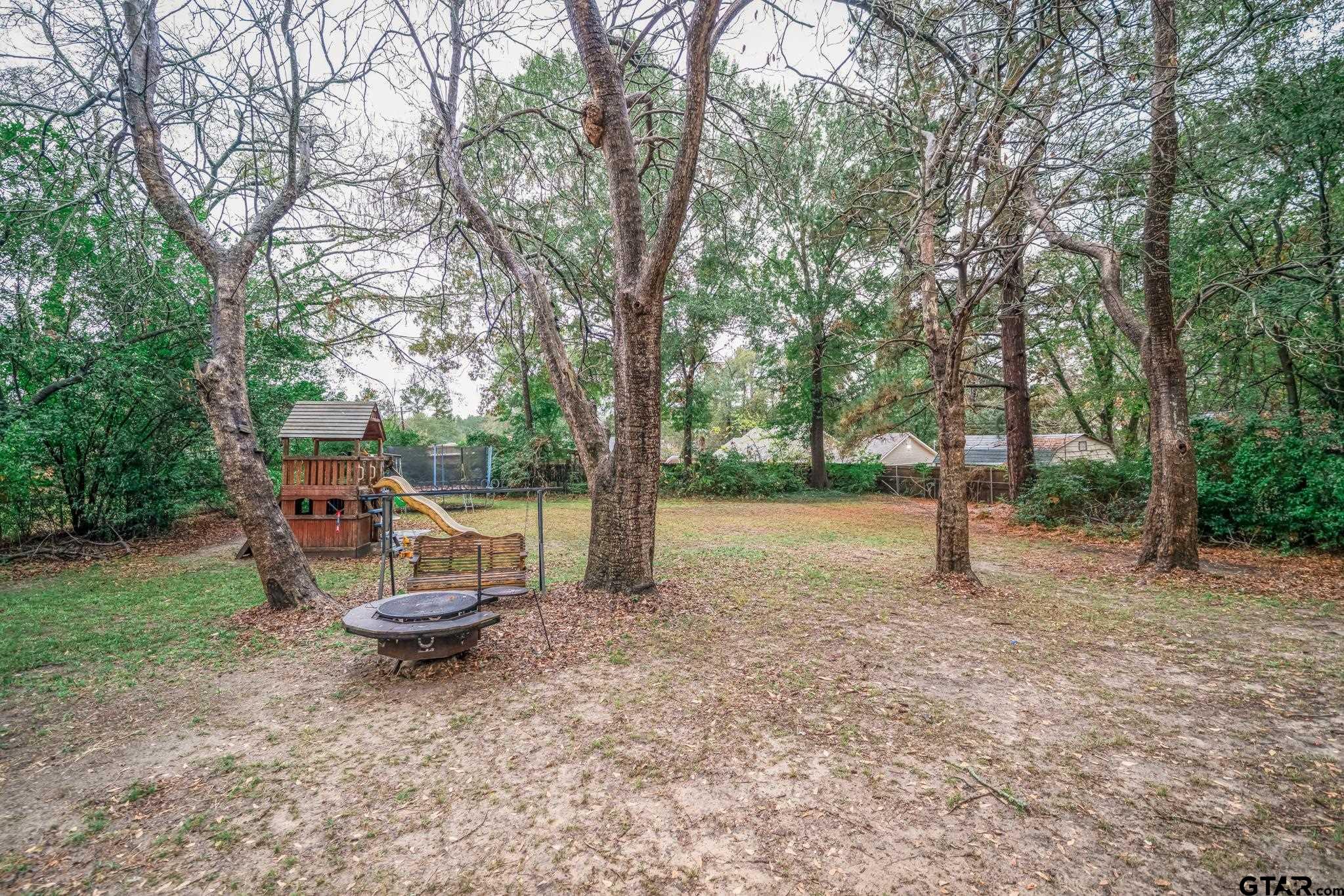 208 East Center Street White Oak, TX 75693 - Photo 31 of 31 a view of a park with swings and a fire pit