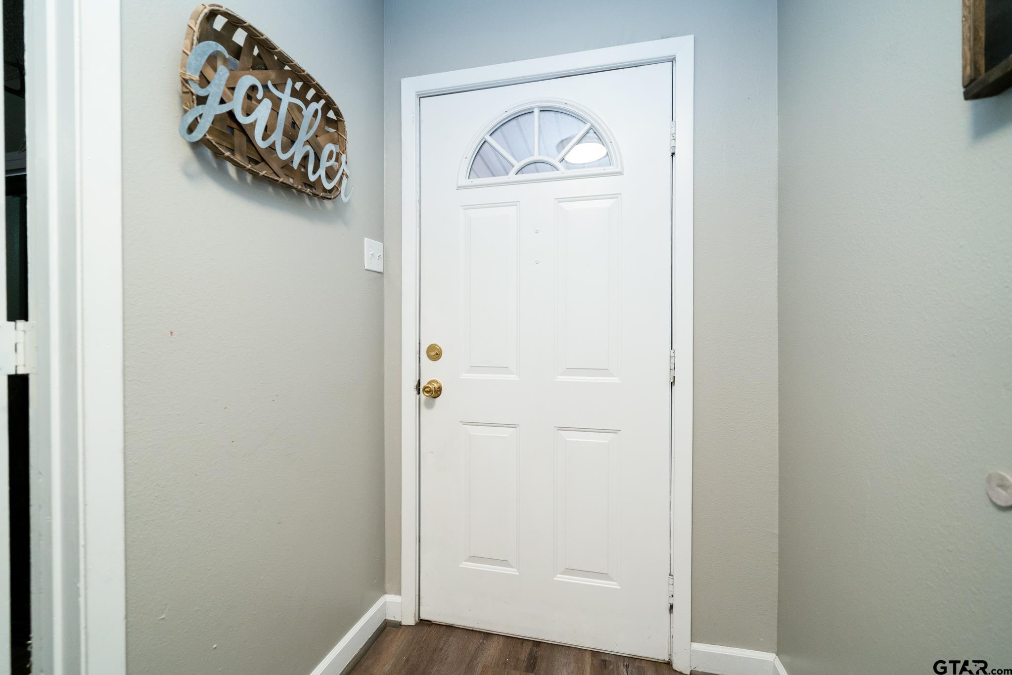 208 East Center Street White Oak, TX 75693 - Photo 5 of 31 a view of a door and a window in a room
