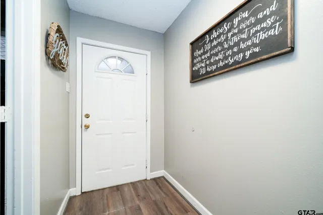 a view of front door with wooden floor