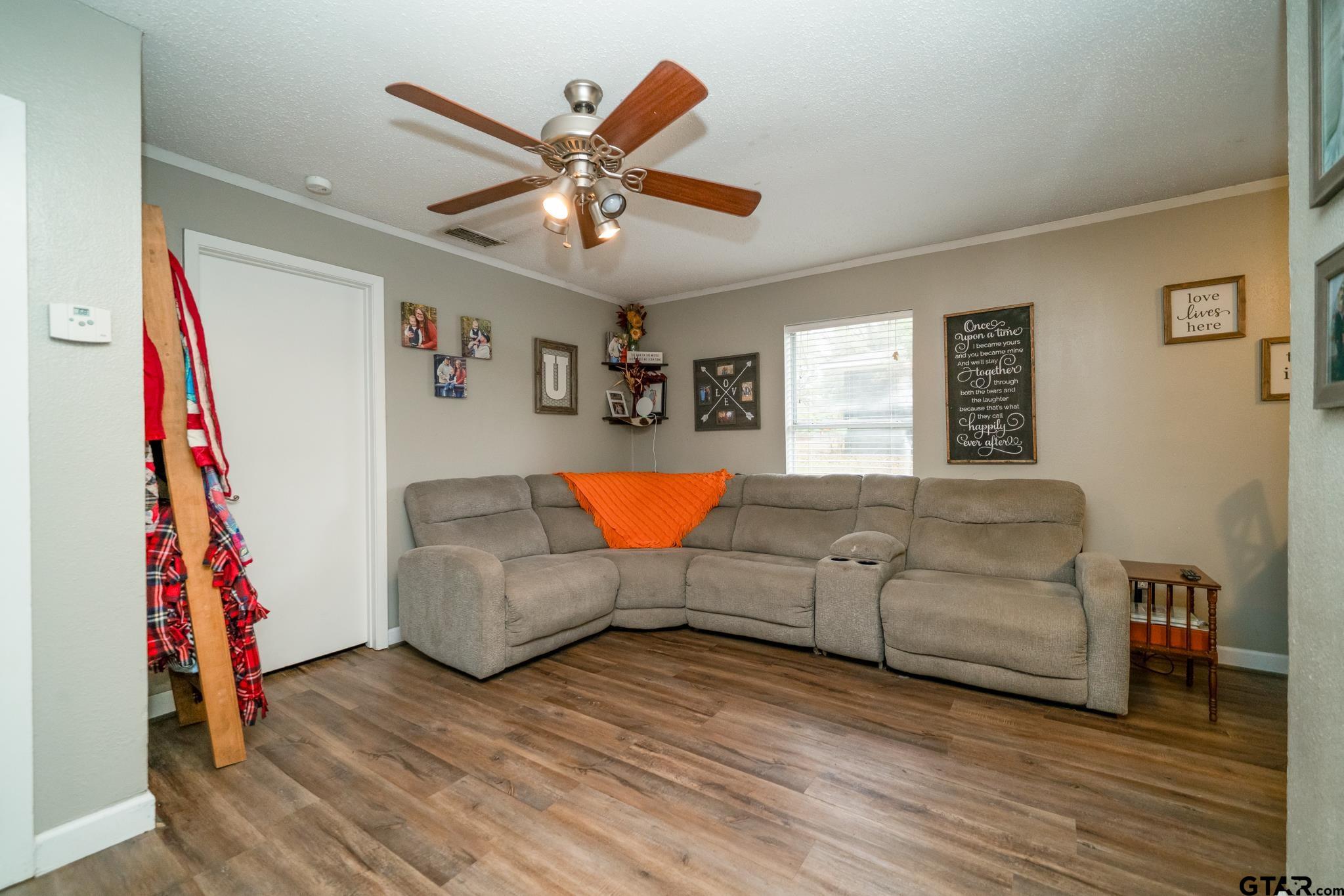 208 East Center Street White Oak, TX 75693 - Photo 10 of 31 a living room with furniture and a flat screen tv