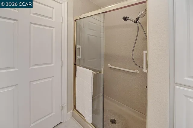 a bathroom with a glass shower door