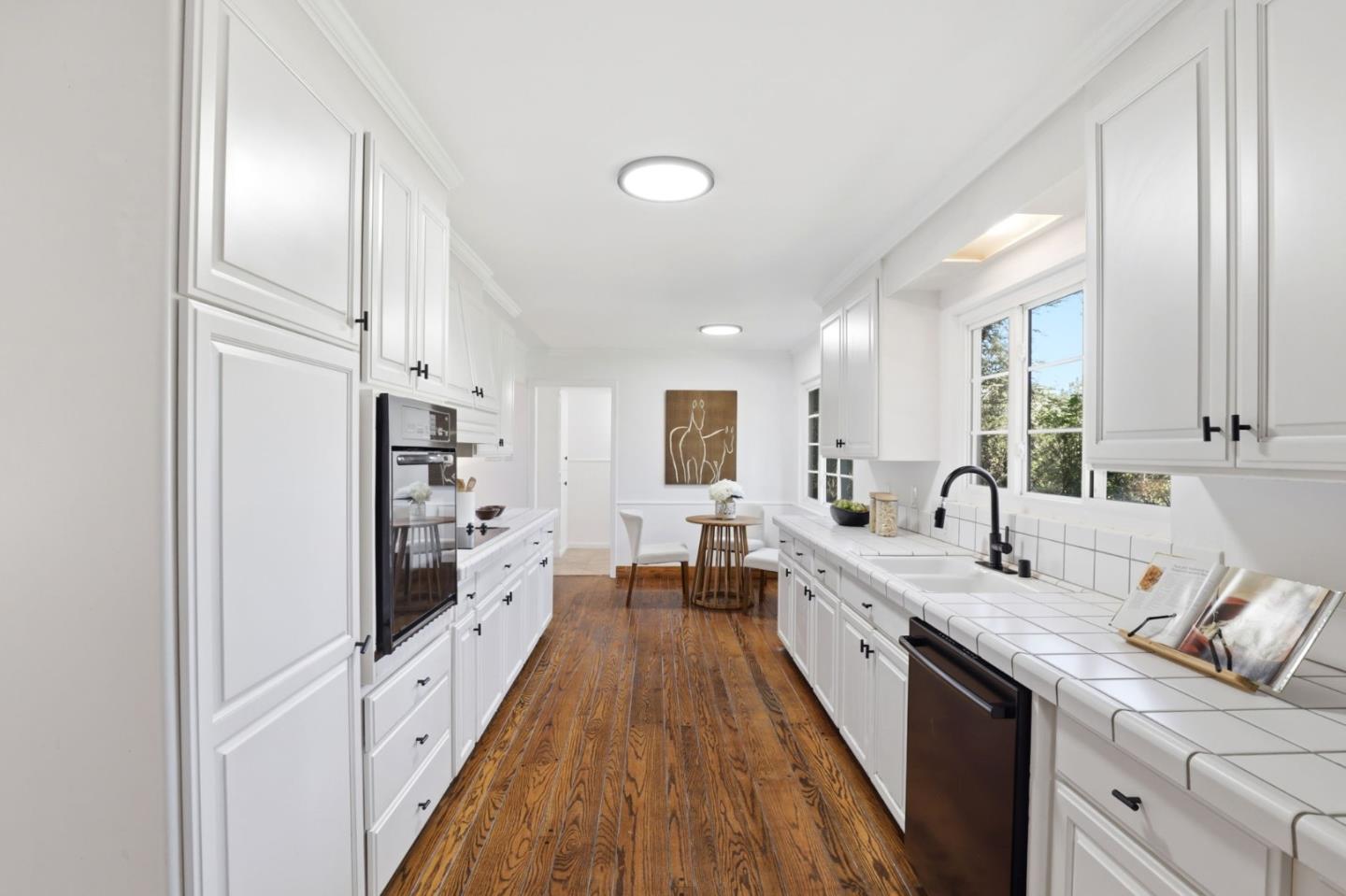 425 Summit Spring Road Woodside, CA 94062 - Photo 12 of 42 a large white kitchen with a large window a sink and stainless steel appliances