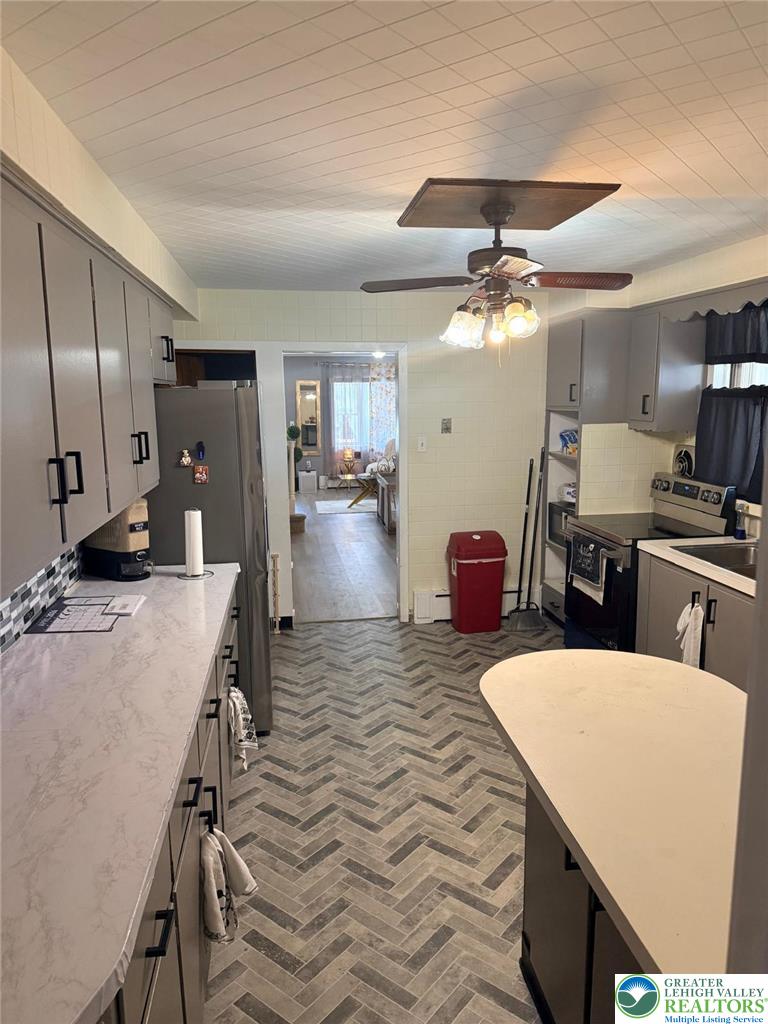 617 South 5th Street Allentown, PA 18103 - Photo 7 of 19 a large kitchen with a table chairs refrigerator and microwave