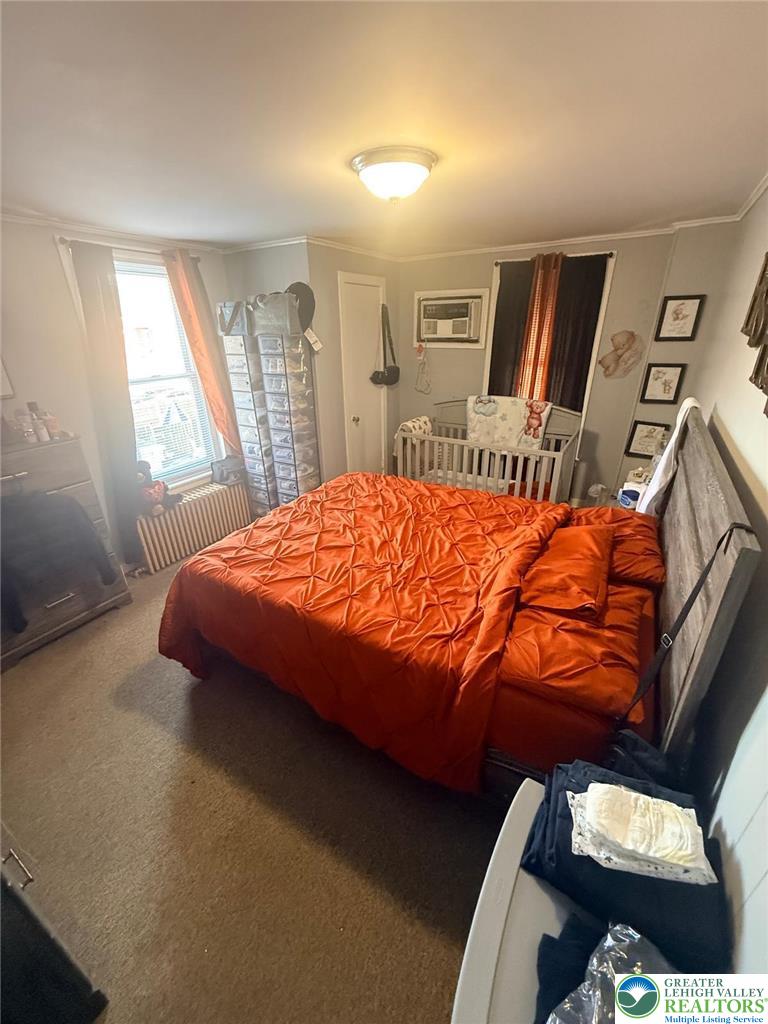 617 South 5th Street Allentown, PA 18103 - Photo 9 of 19 a bedroom with a bed and wooden floor