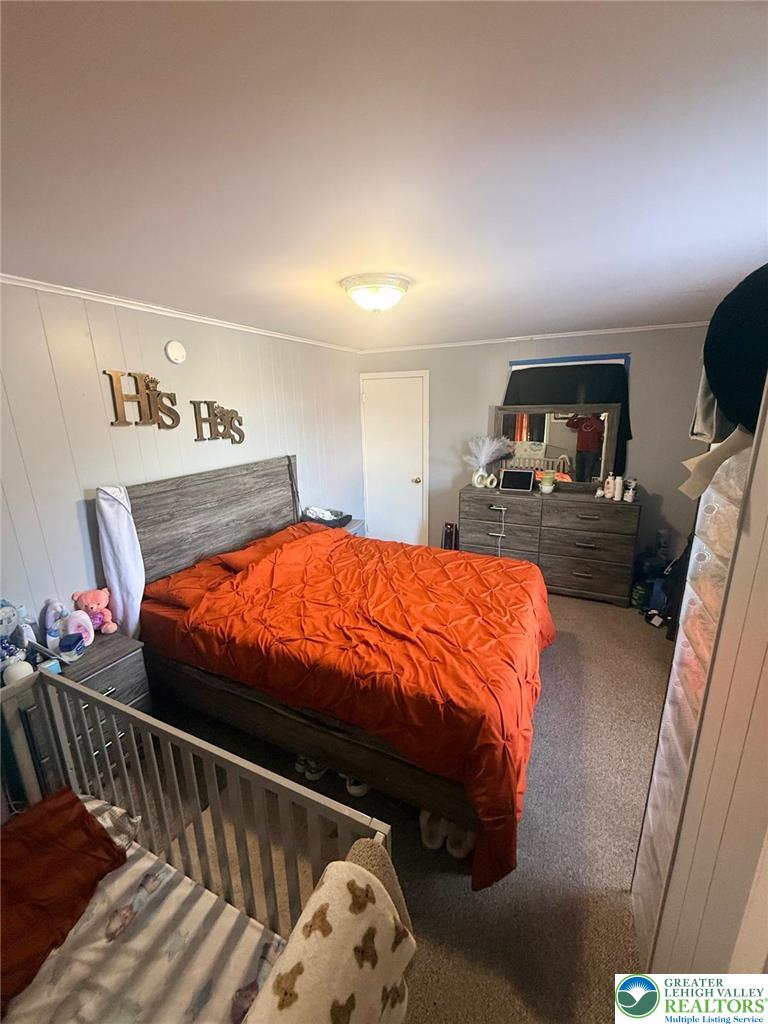617 South 5th Street Allentown, PA 18103 - Photo 10 of 19 a bed sitting in a bedroom next to a window