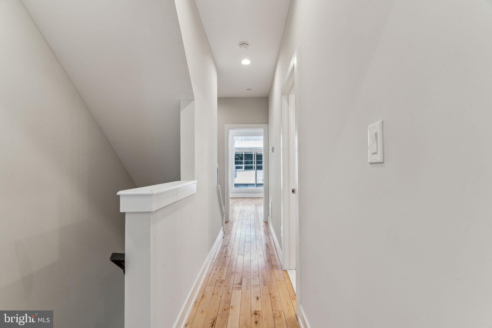 1335 North 30th Street Philadelphia, PA 19121 - Photo 18 of 58 a view of a hallway with wooden floor and a bathroom