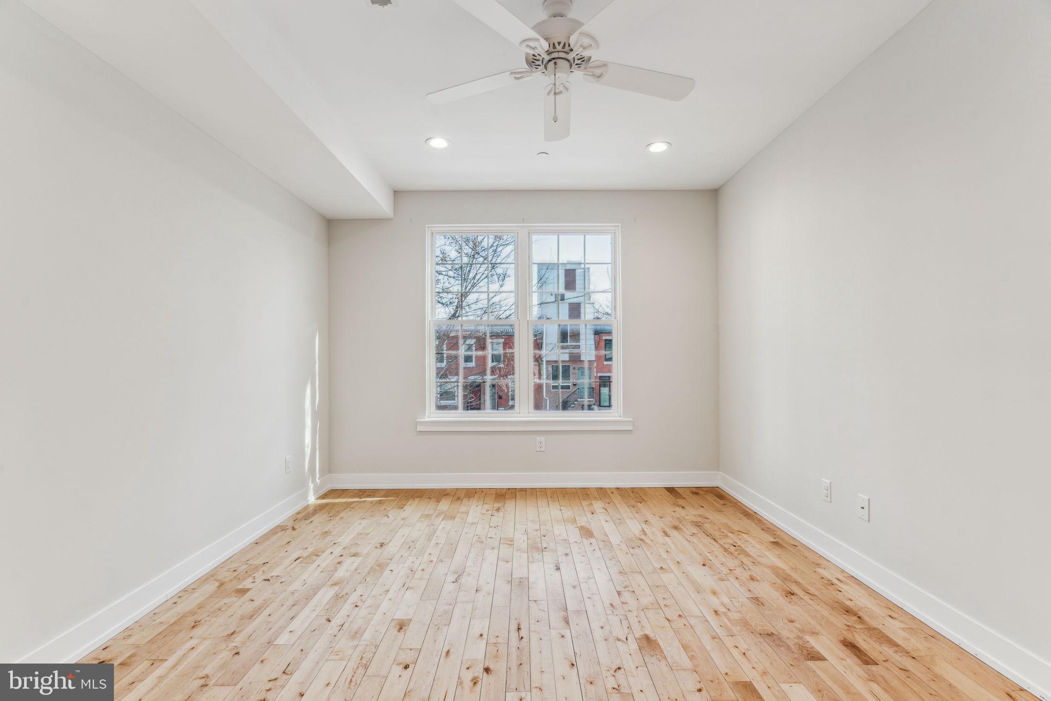 1335 North 30th Street Philadelphia, PA 19121 - Photo 19 of 58 wooden floor in an empty room with a window