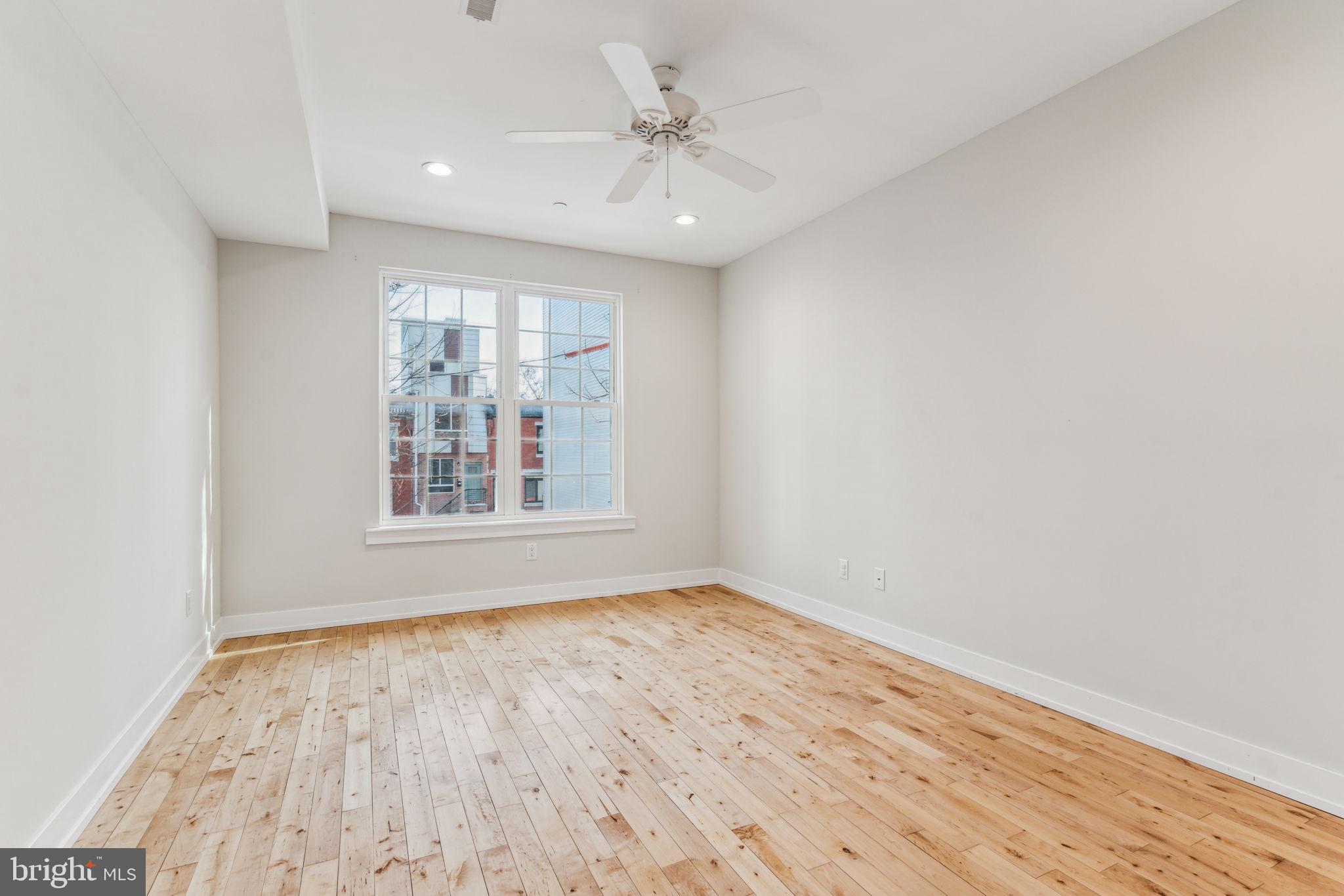 1335 North 30th Street Philadelphia, PA 19121 - Photo 23 of 58 wooden floor in an empty room with a window