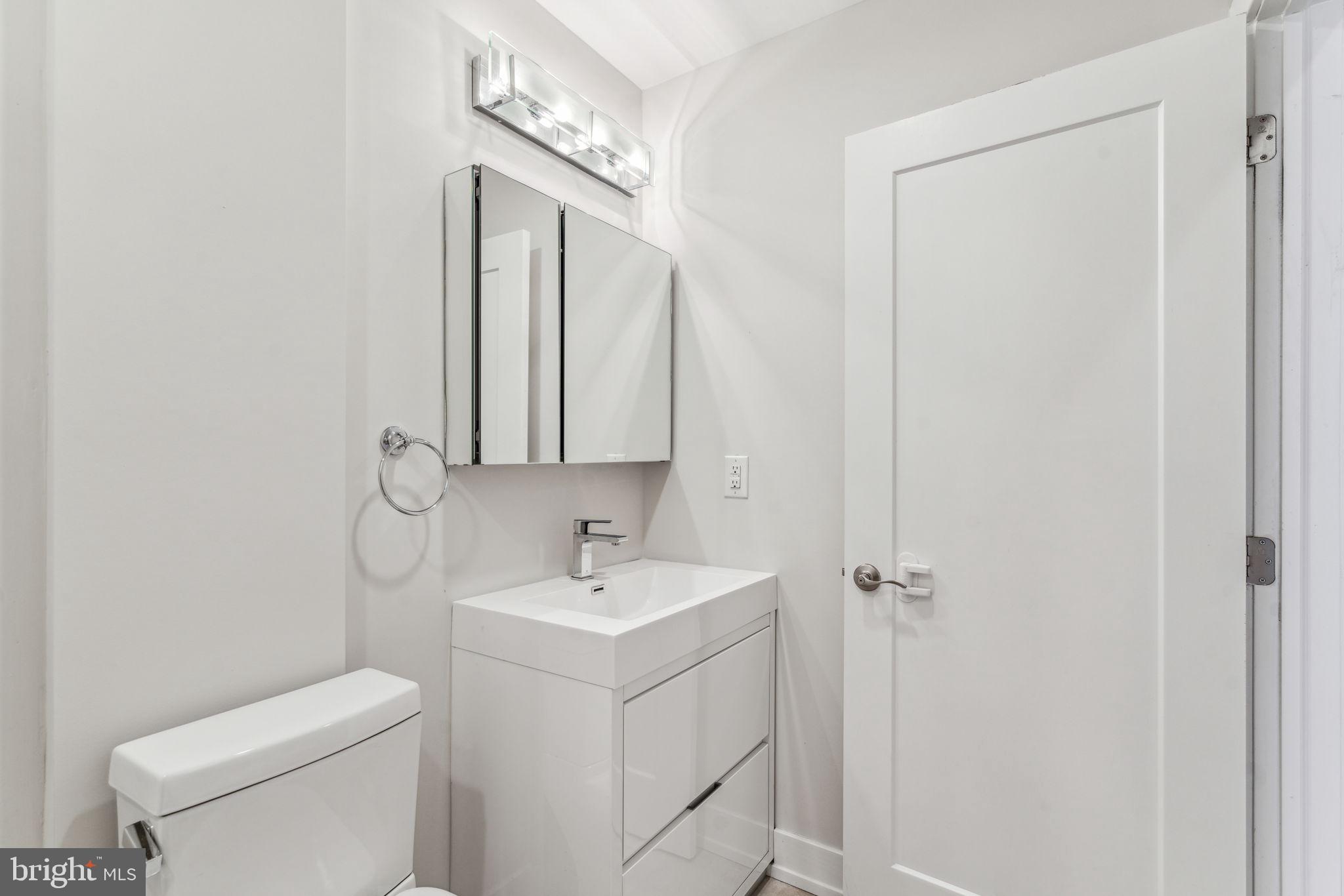 1335 North 30th Street Philadelphia, PA 19121 - Photo 25 of 58 a bathroom with a toilet sink and mirror