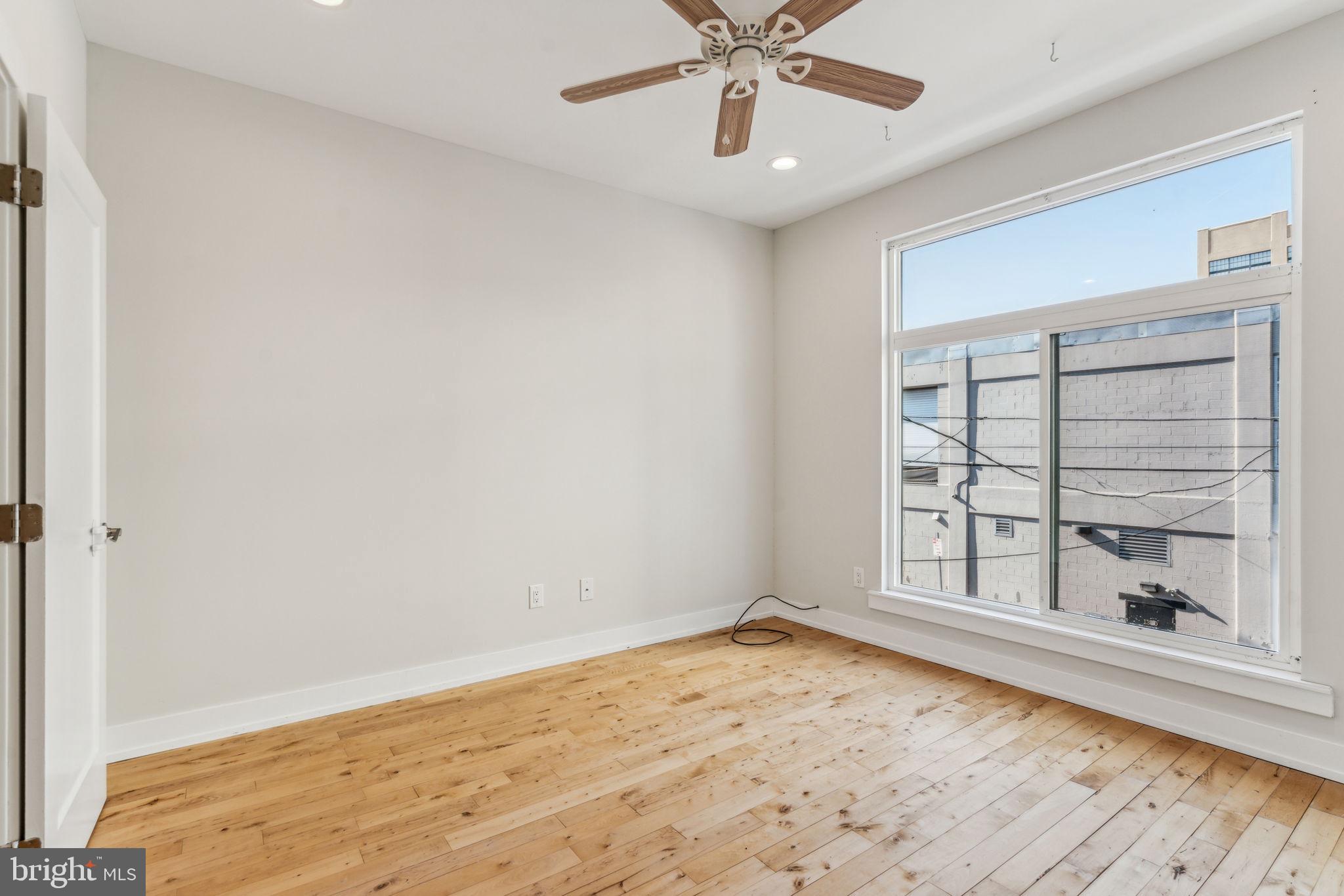 1335 North 30th Street Philadelphia, PA 19121 - Photo 29 of 58 a view of an empty room with a window and wooden floor