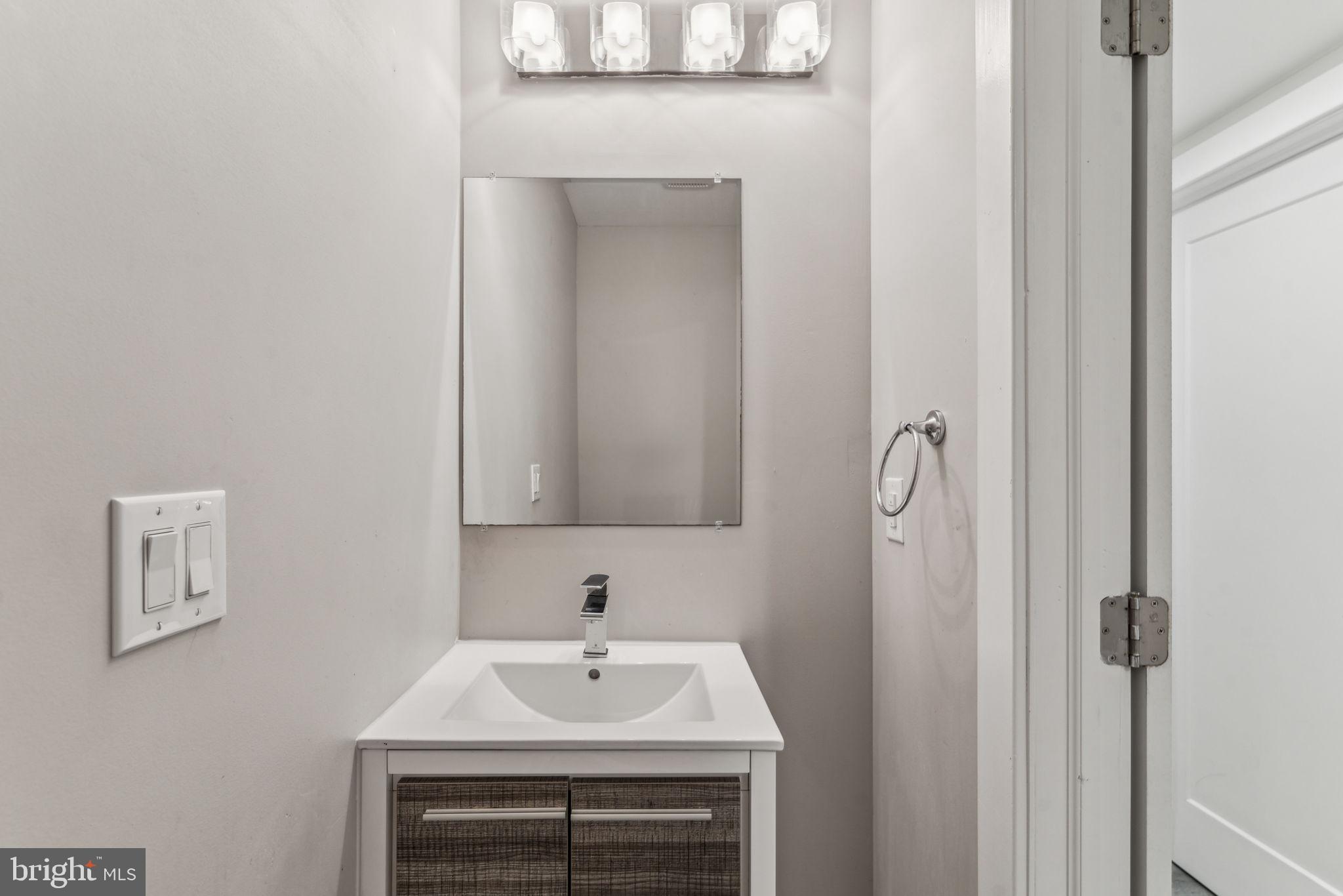 1335 North 30th Street Philadelphia, PA 19121 - Photo 50 of 58 a bathroom with a sink and a mirror