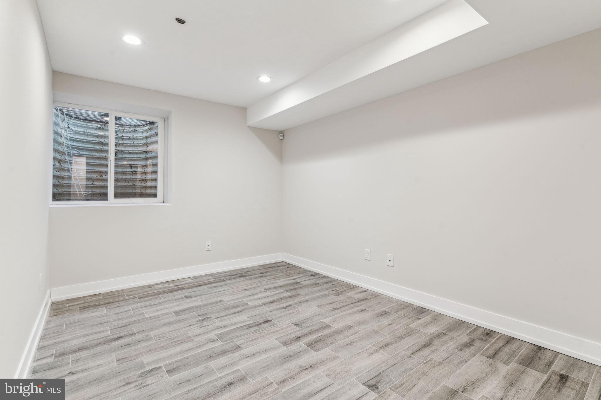 1335 North 30th Street Philadelphia, PA 19121 - Photo 53 of 58 an empty room with wooden floor and windows