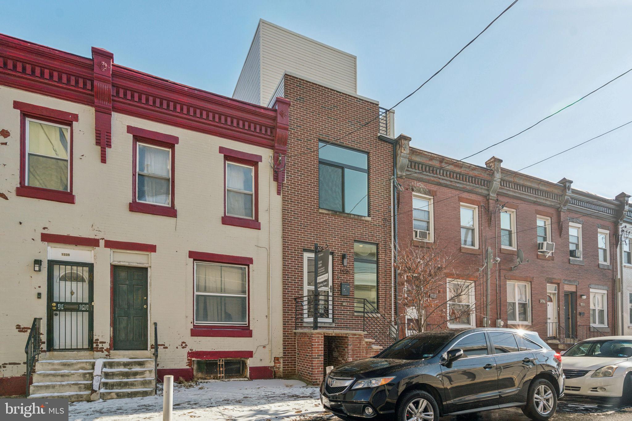 1335 North 30th Street Philadelphia, PA 19121 - Photo 57 of 58 a front view of a building with lot of cars and trees