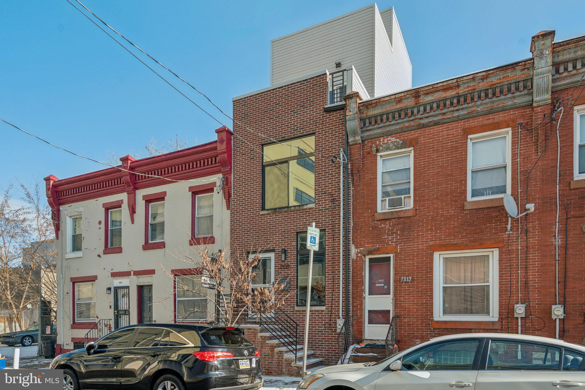 1335 North 30th Street Philadelphia, PA 19121 - Photo 58 of 58 a front view of a building with lot of cars parked on city street