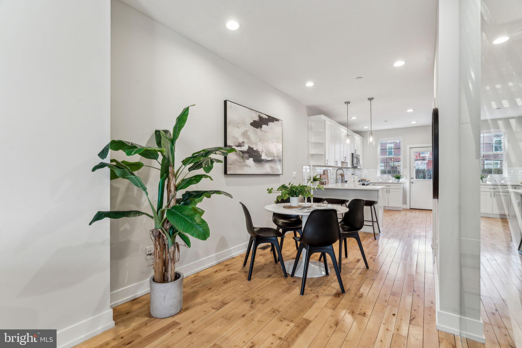 1335 North 30th Street Philadelphia, PA 19121 - Photo 7 of 58 a dining room with furniture and potted plants