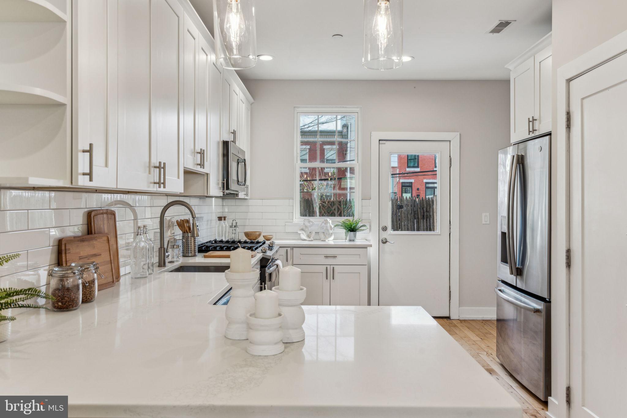 1335 North 30th Street Philadelphia, PA 19121 - Photo 10 of 58 a kitchen with stainless steel appliances a sink a stove a refrigerator and cabinets