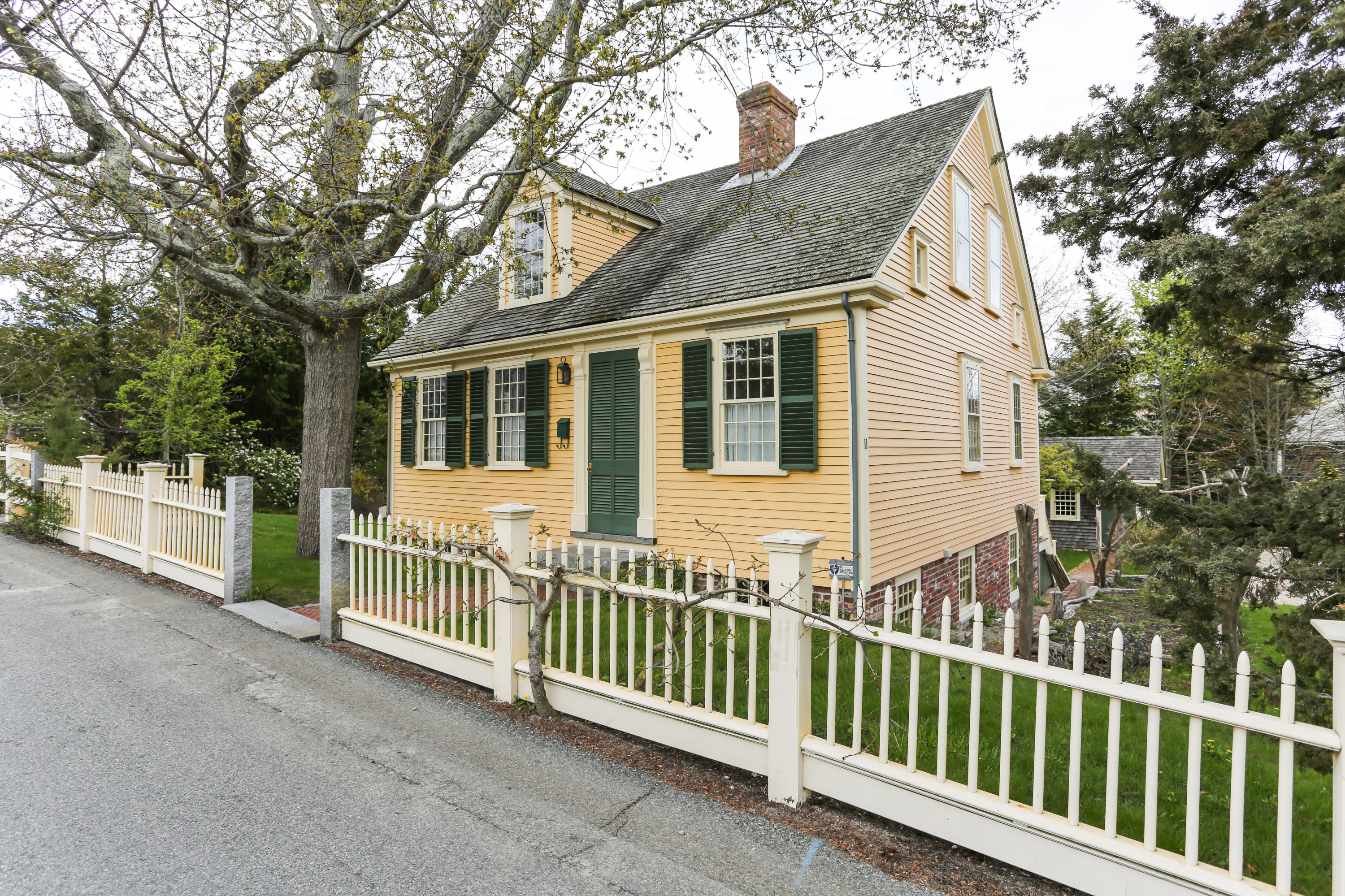 11-15 Franklin Street Provincetown, MA 02657 - Photo 1 of 26 a view of a house with a small yard and large trees