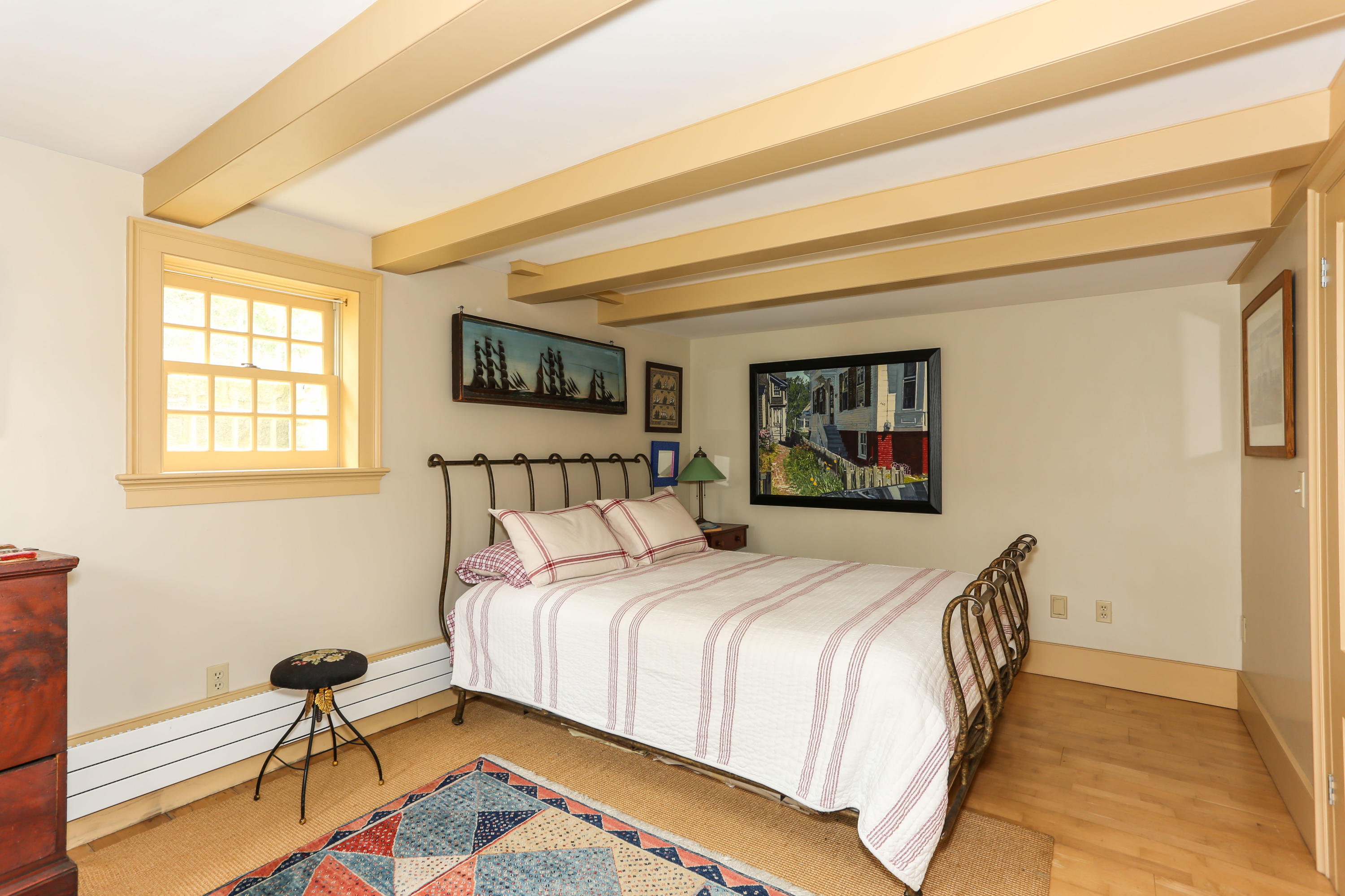 11-15 Franklin Street Provincetown, MA 02657 - Photo 19 of 26 a bedroom with a bed and wooden floor
