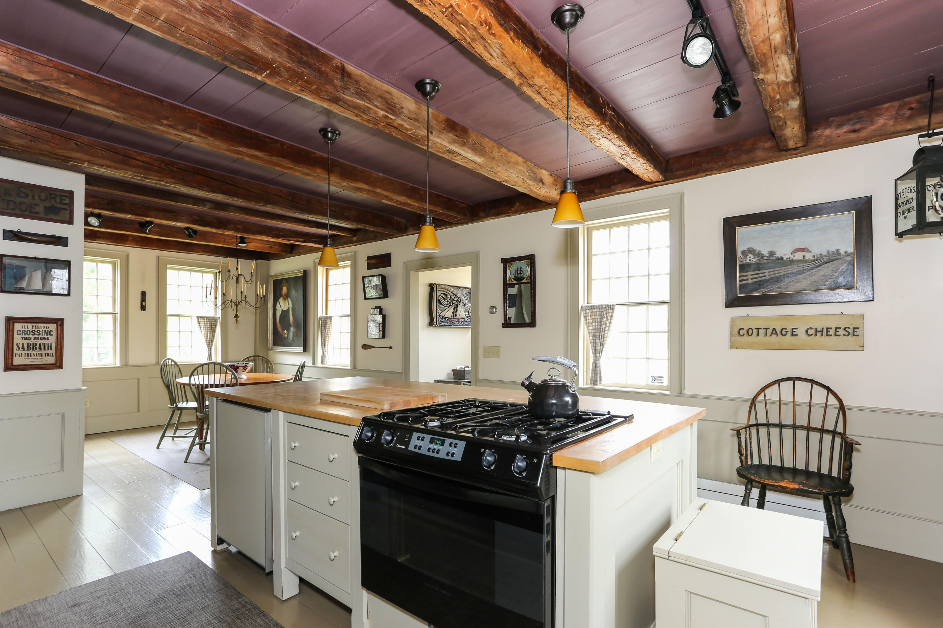 11-15 Franklin Street Provincetown, MA 02657 - Photo 7 of 26 a kitchen that has a stove and a table chair
