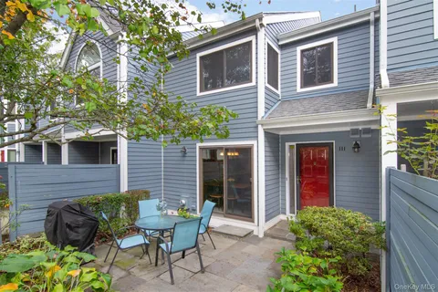 a front view of a house with outdoor seating and plants