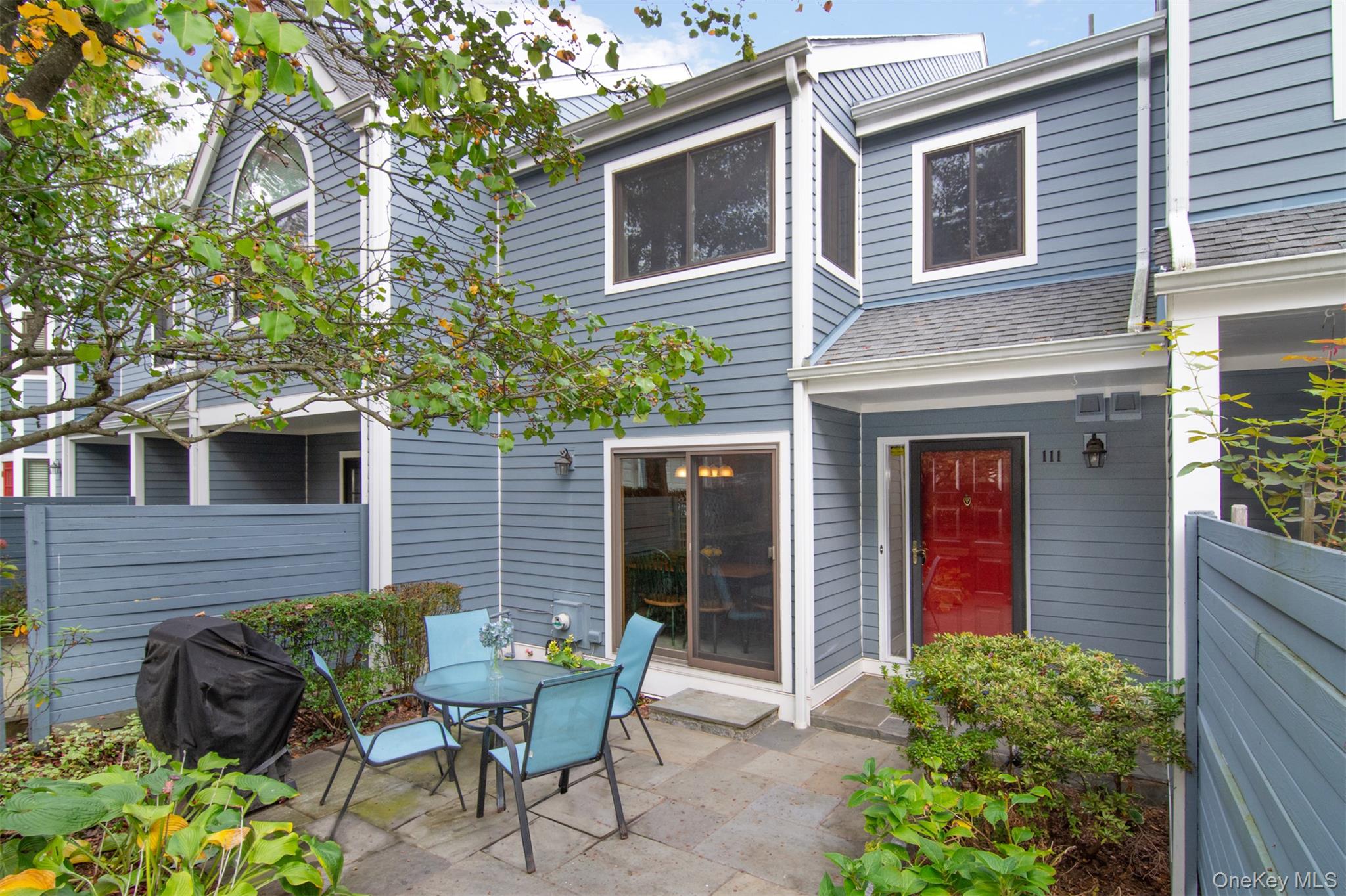 a front view of a house with outdoor seating and plants