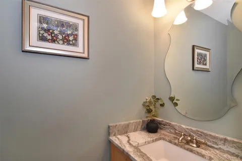 a bathroom with a sink a mirror and vanity