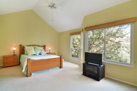 a bedroom with a bed and a tv