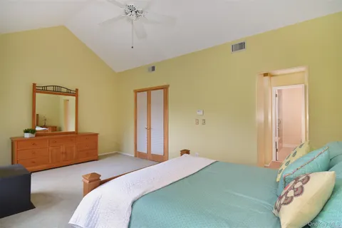 a bedroom with a bed and a couch