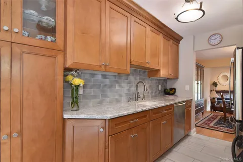 a kitchen with stainless steel appliances granite countertop a sink and cabinets