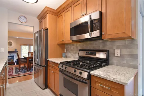 a kitchen with stainless steel appliances granite countertop a stove and a microwave