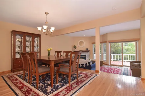 a view of a dining room with furniture a chandelier and wooden floor