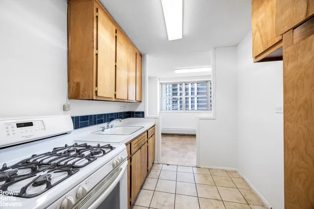 a view of livingroom with kitchen and entryway