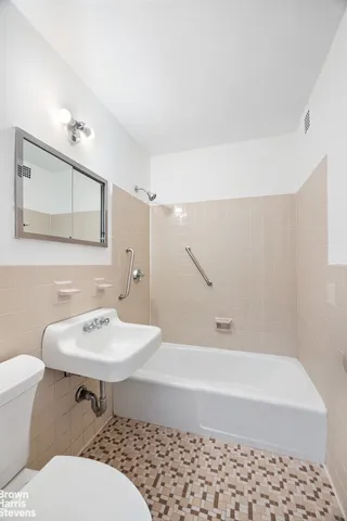 a kitchen with a stove a sink and a window