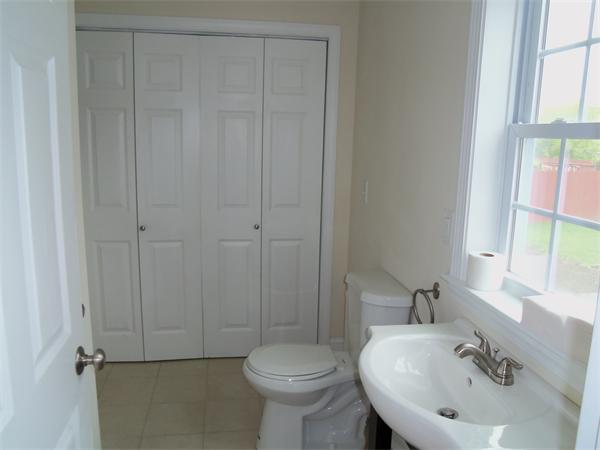 8 Reeves Street Fall River, MA 02721 - Photo 4 of 13 a bathroom with a sink a toilet and a mirror