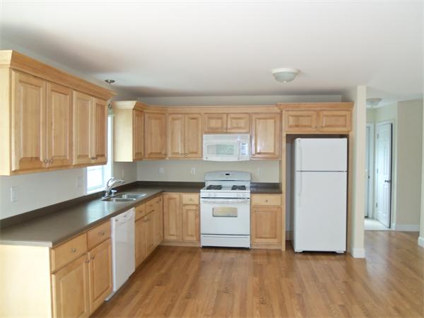 8 Reeves Street Fall River, MA 02721 - Photo 6 of 13 a kitchen with a stove a sink and a refrigerator