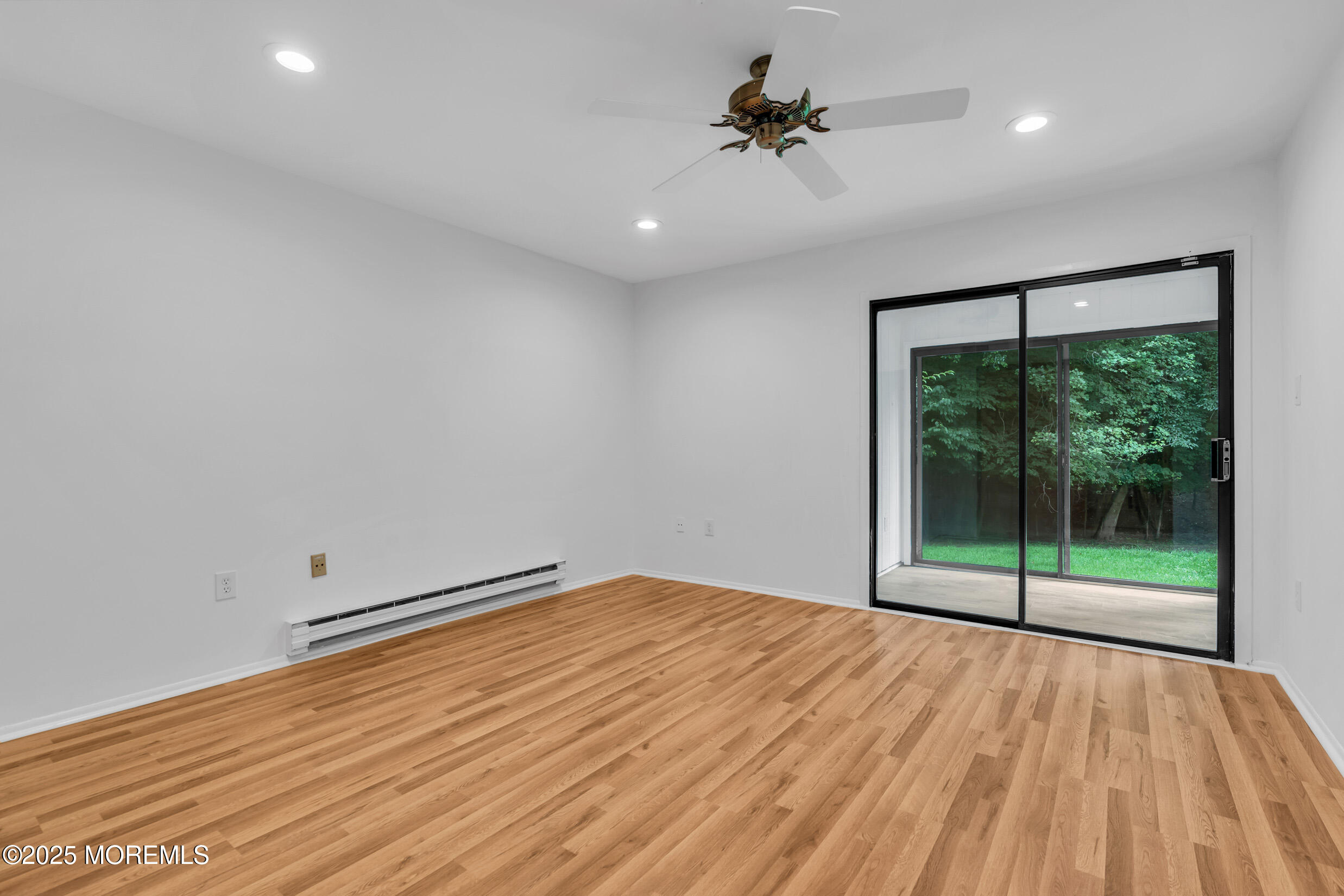 70 Overlook Way, Unit A Manalapan, NJ 07726 - Photo 13 of 20 a view of empty room with wooden floor and fan