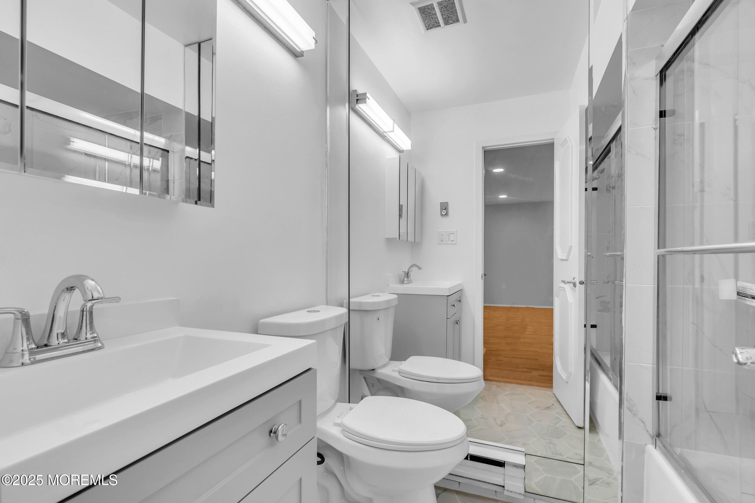 70 Overlook Way, Unit A Manalapan, NJ 07726 - Photo 14 of 20 a bathroom with a sink toilet vanity and shower